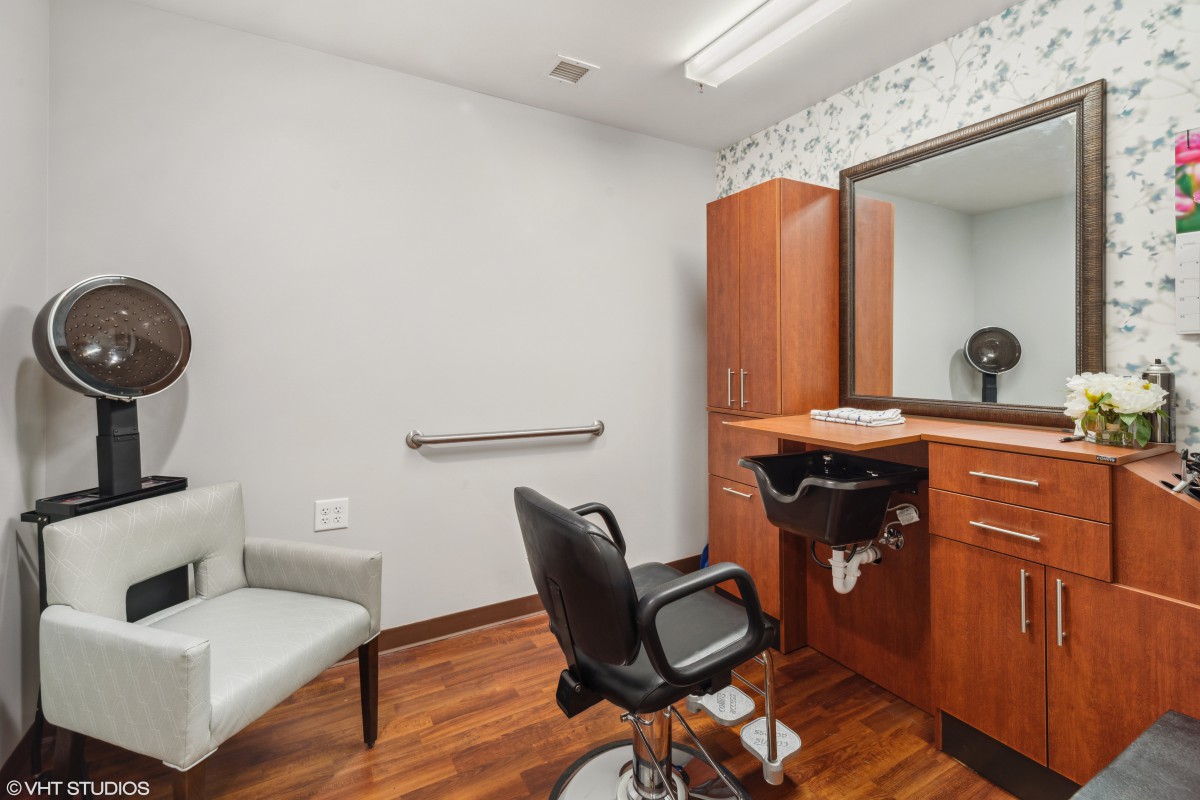 Stylish and modern barbershop interior with a comfortable chair and large mirror.
