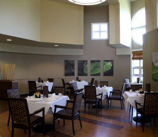 A spacious and elegantly designed dining area in a modern restaurant.