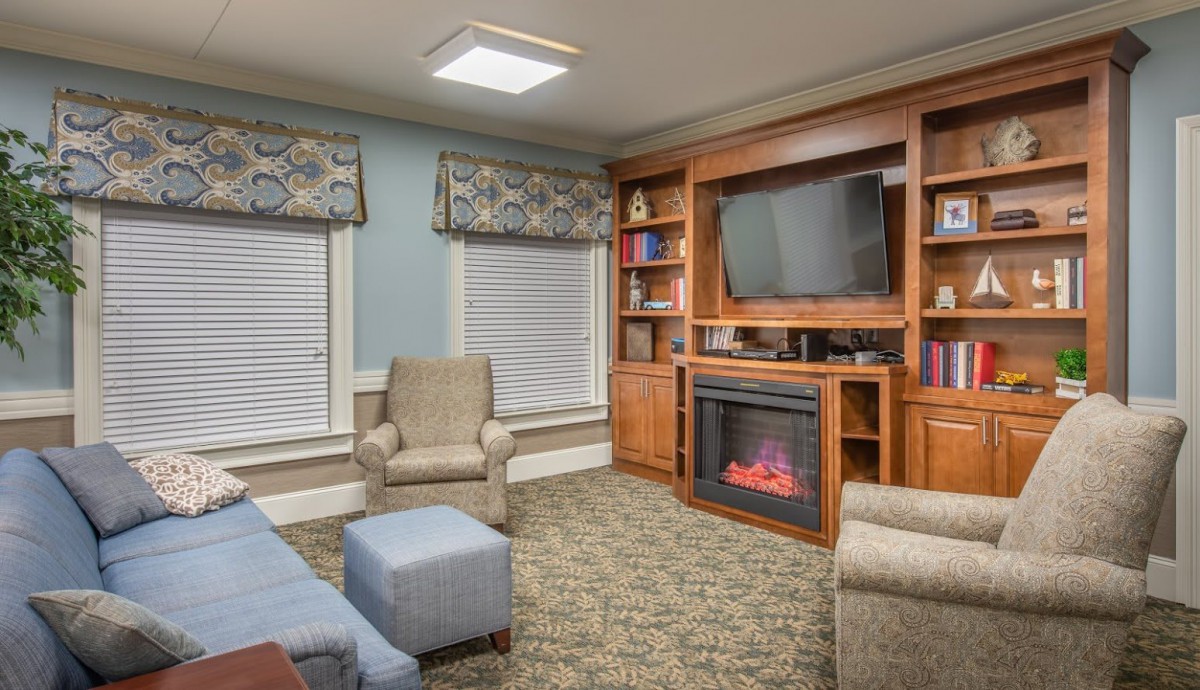 A cozy living room with a fireplace, television, and comfortable seating.