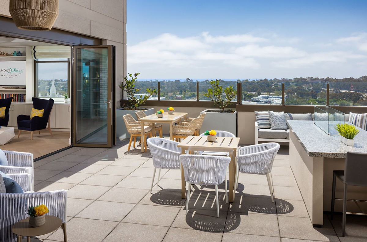 A modern outdoor terrace with comfortable seating and a scenic view.
