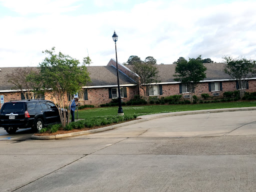 A peaceful suburban street showcasing a well-kept residential home with a landscaped yard.