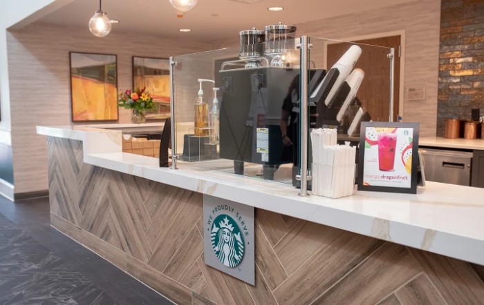 Interior view of a Starbucks coffee counter with drink dispensers and cups.