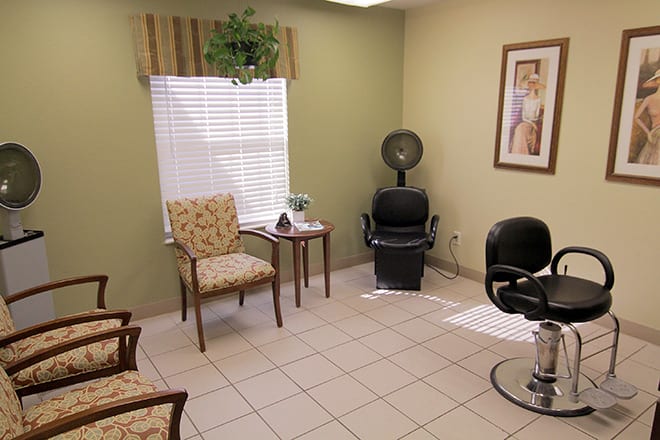 A cozy hair salon interior with seating and a hair dryer.
