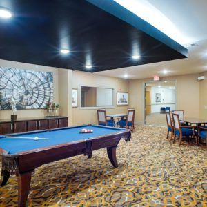 A modern indoor game room featuring a pool table and stylish decor.