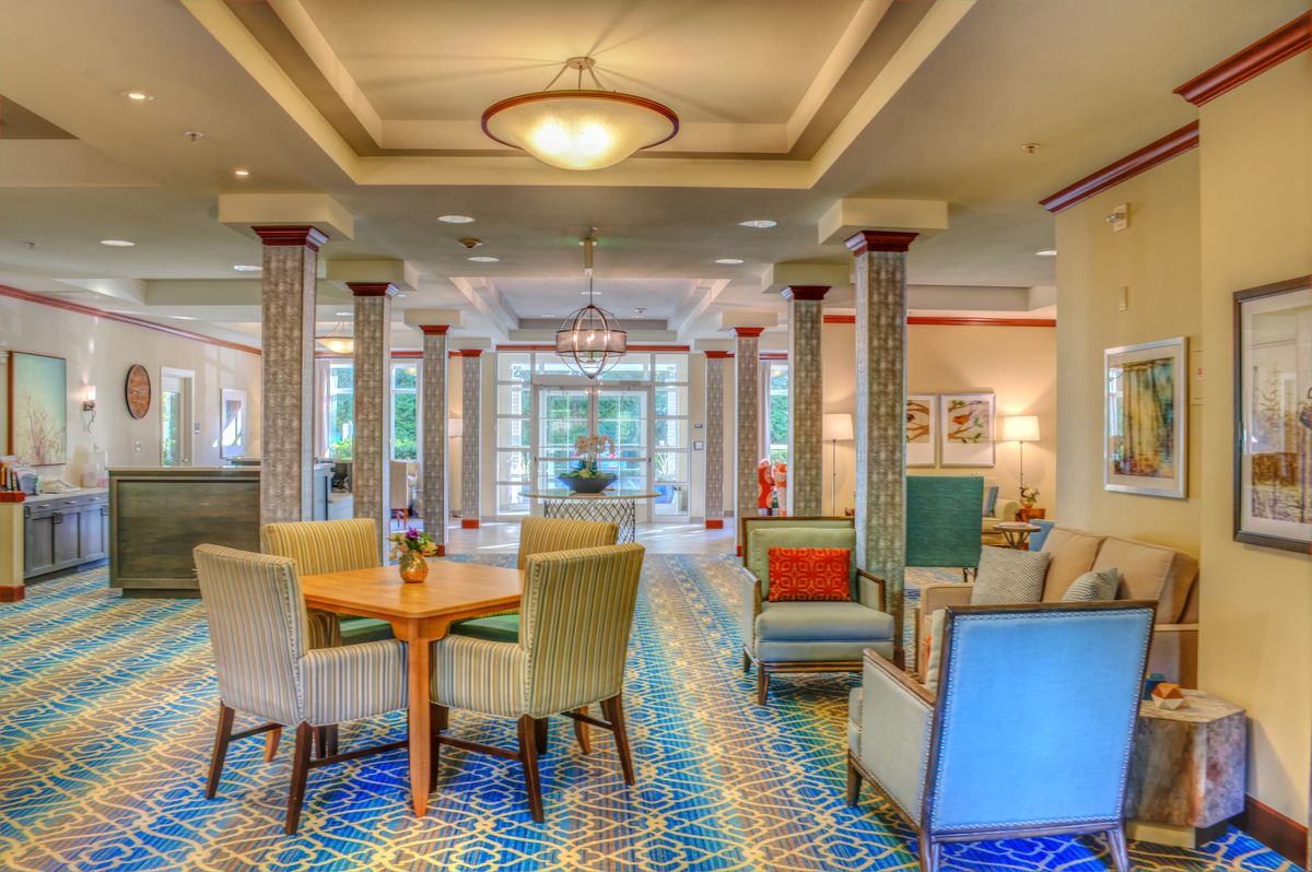 A cozy and well-lit hotel lobby with comfortable seating and elegant decor.