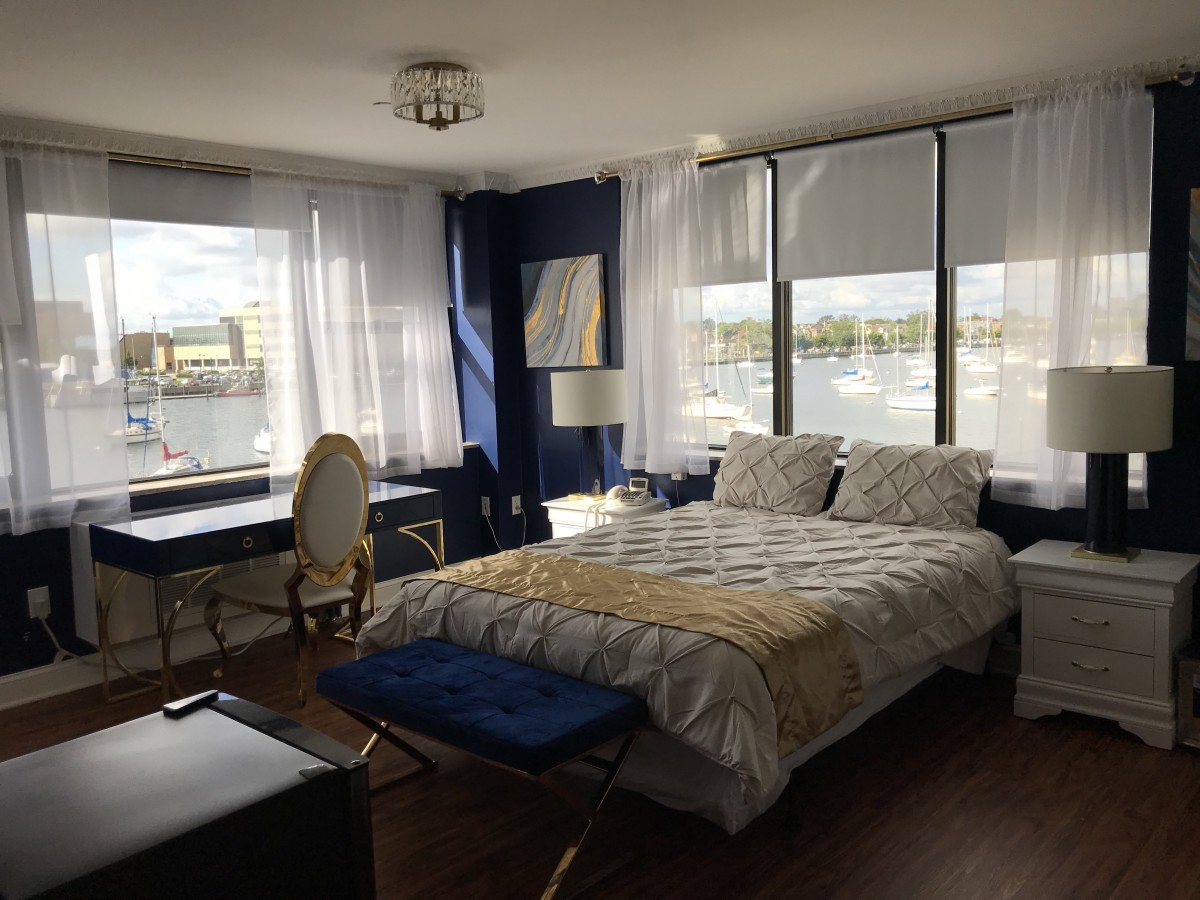 A modern bedroom with natural light and a scenic window view.