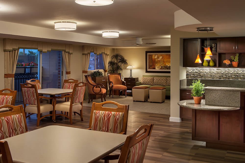A cozy living and dining area with warm lighting, comfortable furniture, and tasteful decor.