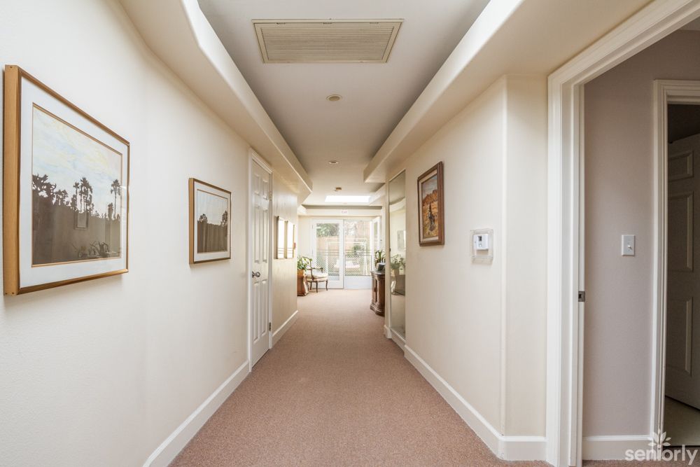 A bright and inviting hallway with artwork adorning the walls.