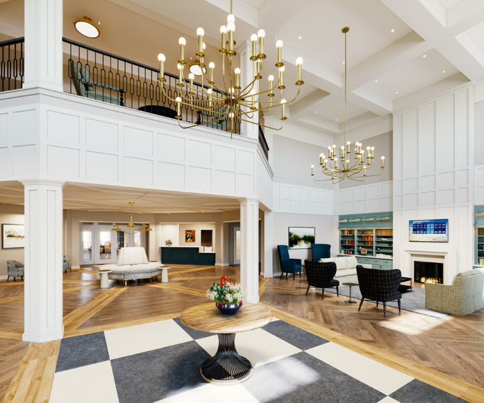 A spacious and elegantly designed lobby featuring high ceilings, chandeliers, and comfortable seating areas.