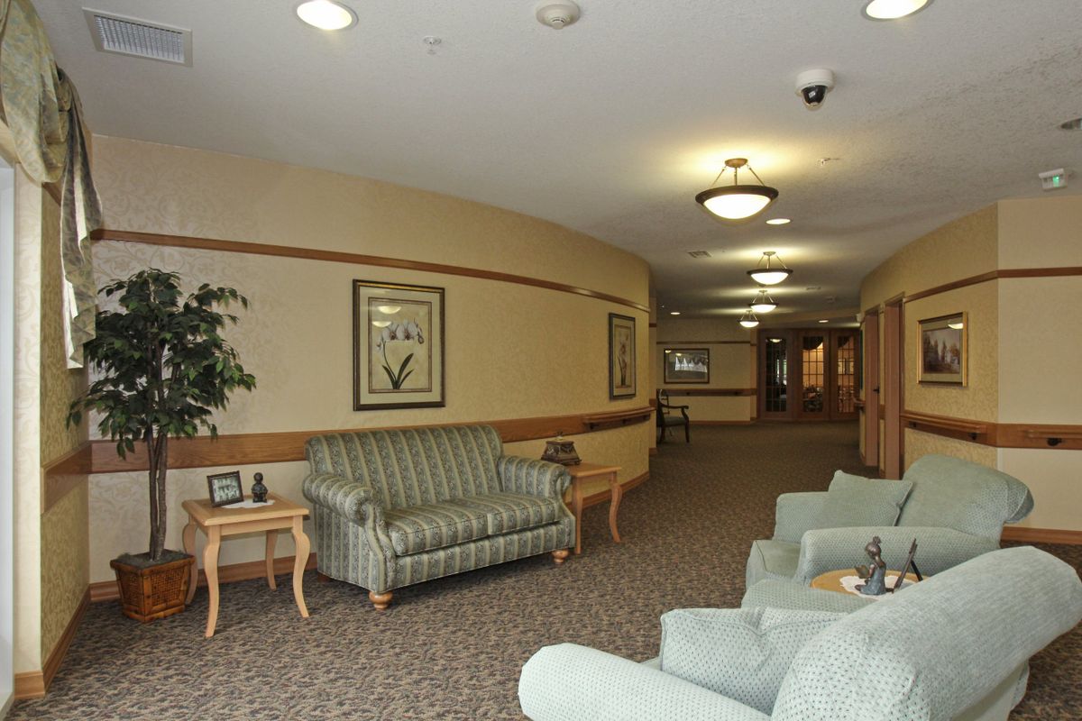 A cozy hallway with sofas and soft lighting, resembling a lounge or waiting area.