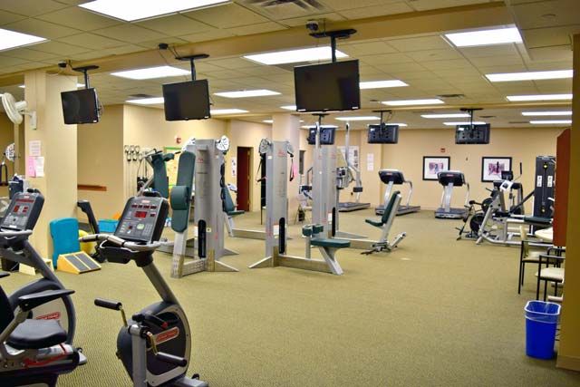 A well-equipped gym with various fitness machines and cardio equipment.
