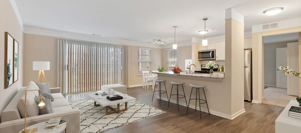 A modern open-concept living room and kitchen area with stylish decor and comfortable seating.