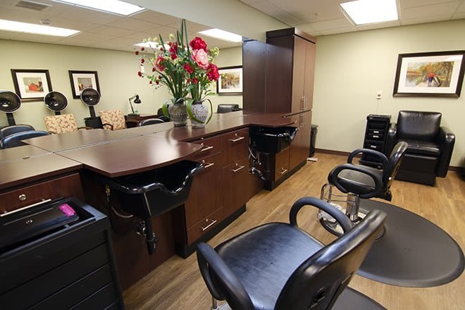 Interior of a hair salon with styling stations and chairs.
