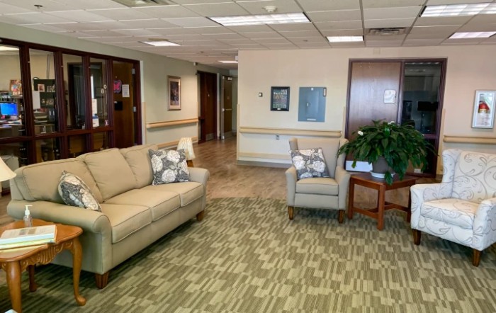 A cozy waiting room with comfortable seating and indoor plants.