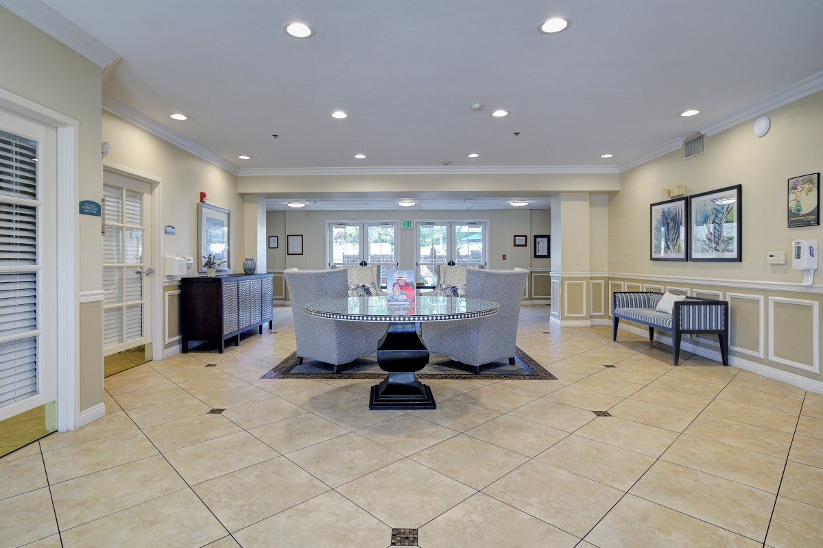 A modern and spacious lobby with stylish furniture and tiled flooring.