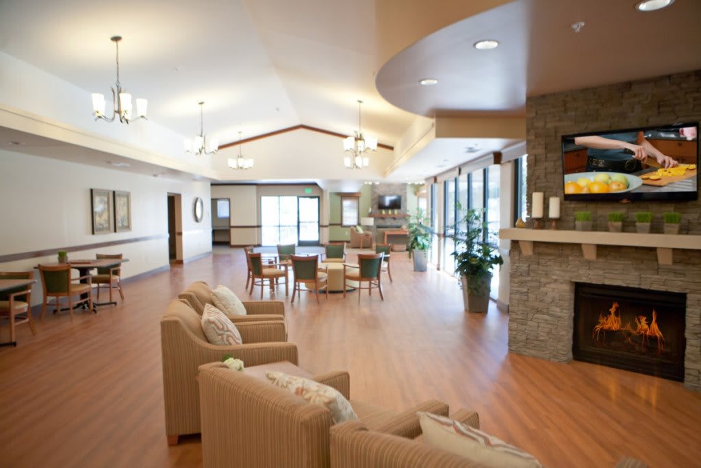 Spacious and well-lit living room with comfortable seating and a fireplace.