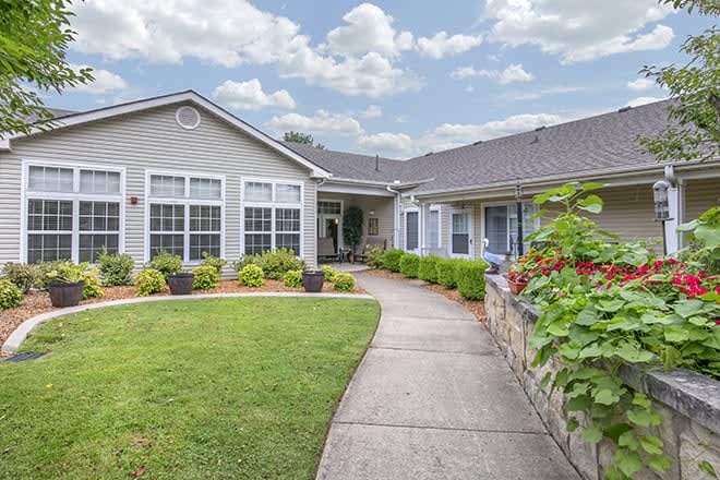 A charming residential house with a well-maintained front yard and garden.
