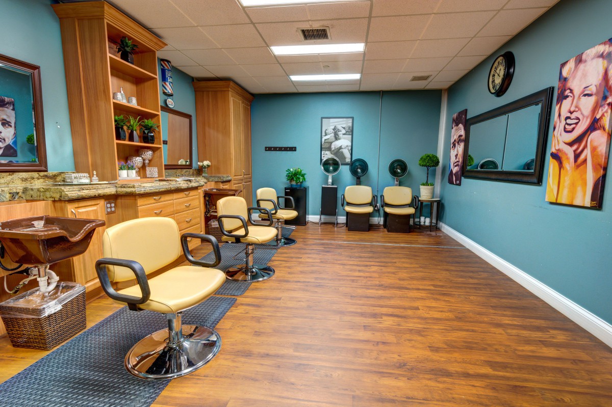 A modern hair salon with stylish chairs and a waiting area.