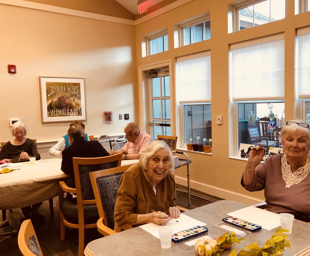 A group of seniors participating in an art class at a community center.