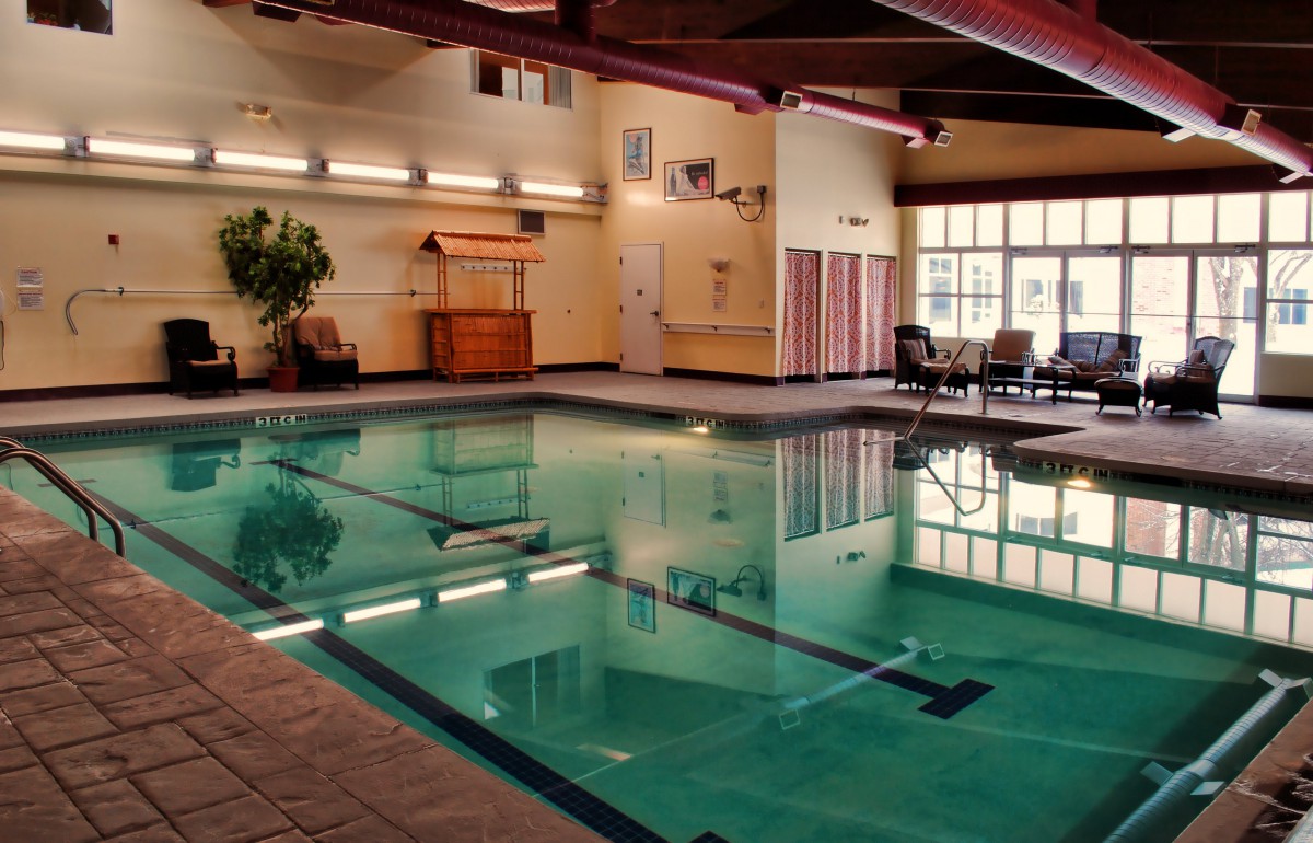 An inviting indoor swimming pool with a relaxation area.