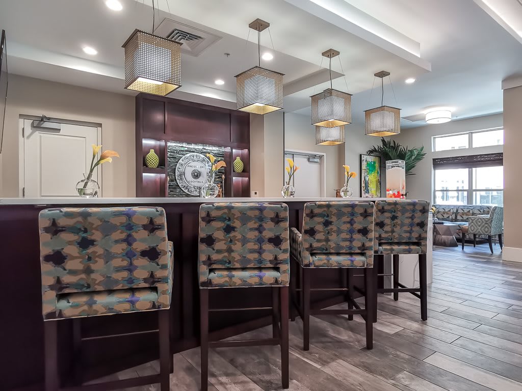 A modern bar area with stylish seating and elegant lighting.