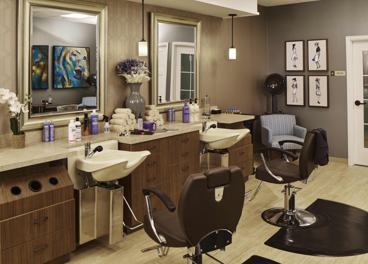 A well-equipped hair salon with styling stations, chairs, and hair care products.