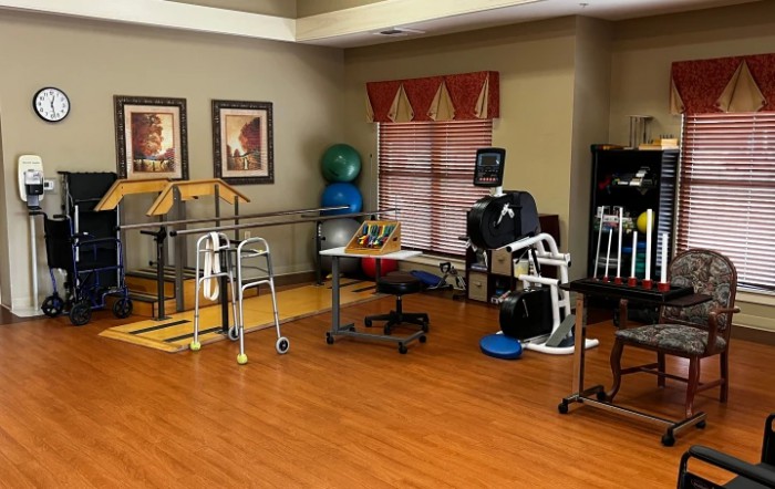 A rehabilitation room equipped with various physical therapy tools and exercise equipment.