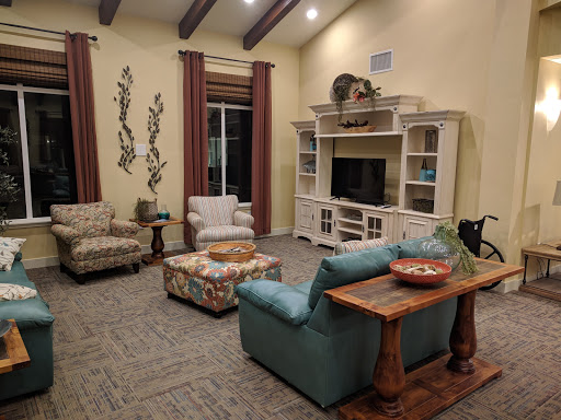 A cozy living room featuring comfortable seating and a TV setup, ideal for relaxation and gatherings.