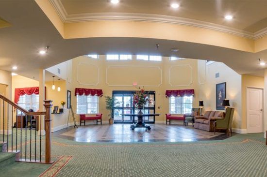 Spacious lobby interior with seating and decor.