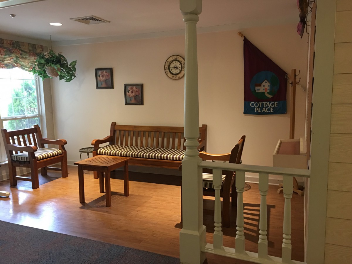 A cozy living room with wooden furniture and decorative items.