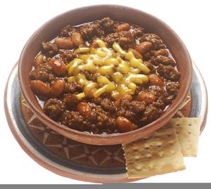 A bowl of chili topped with cheese, served with crackers.