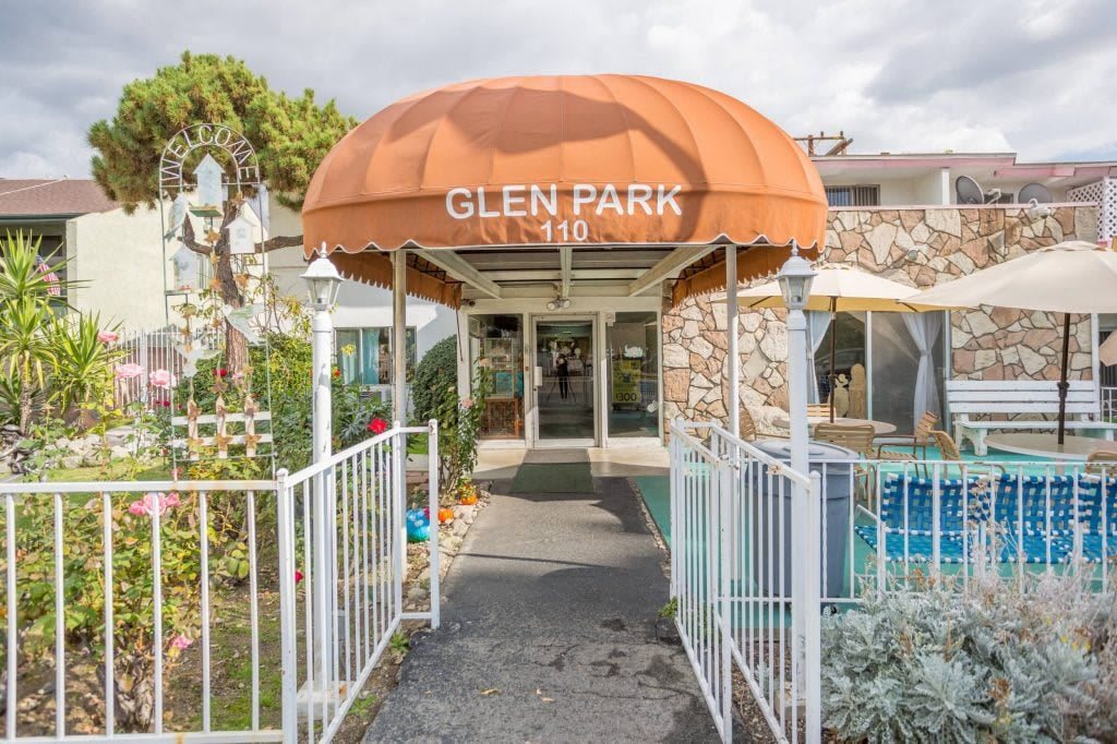 Entrance to a building with an orange awning labeled 'Glen Park'.