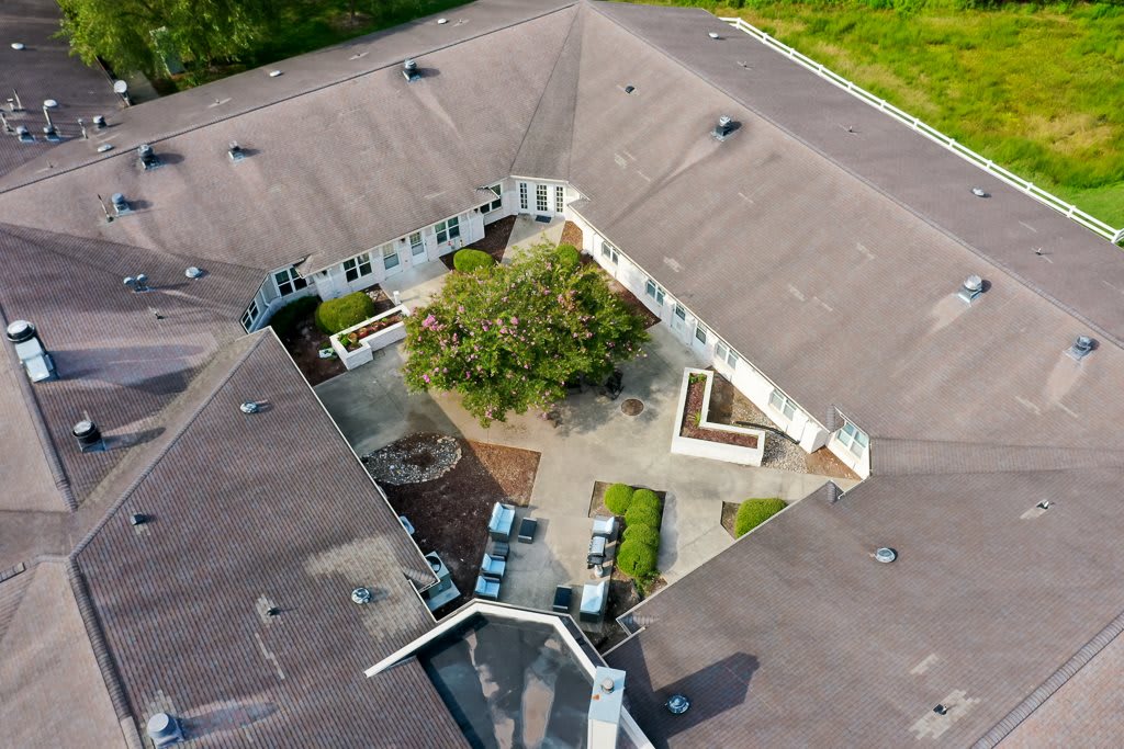 Aerial view of a building with a central courtyard featuring greenery.