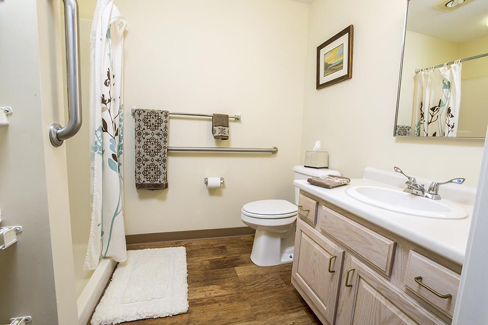 A neatly organized bathroom with essential fixtures and decor.