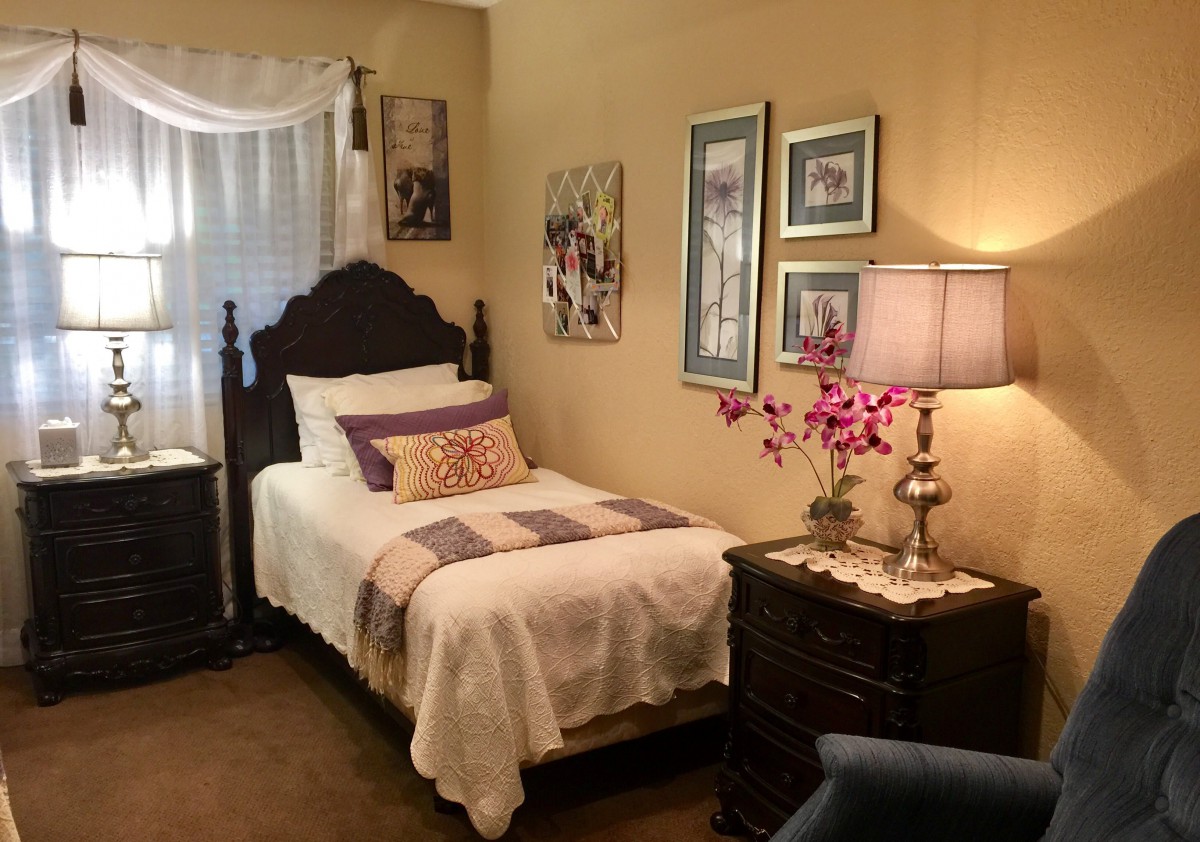 A cozy bedroom with traditional furnishings and decorative elements.