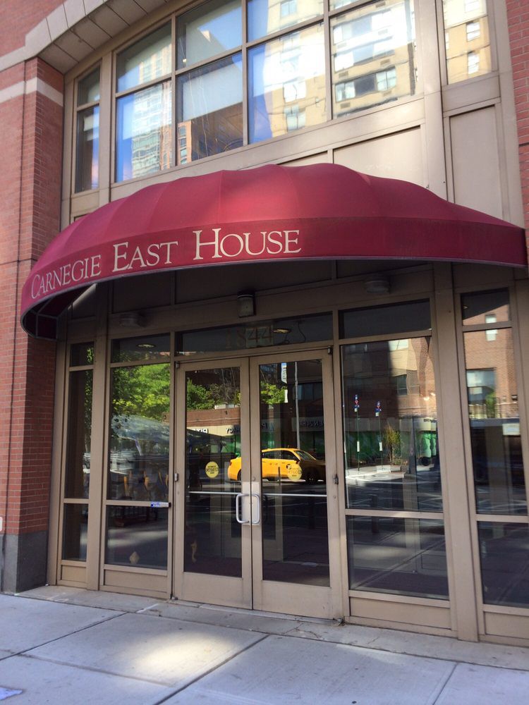 Entrance to a building with a red awning labeled 'Circle East House'.