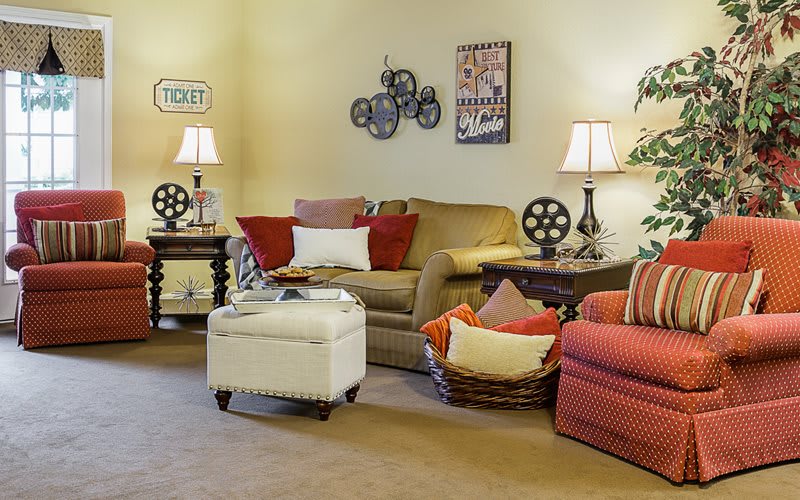 A cozy living room with comfortable seating, stylish lighting, and tasteful wall art.