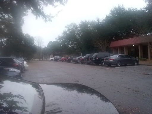 A view of a parking lot filled with cars on a cloudy day.