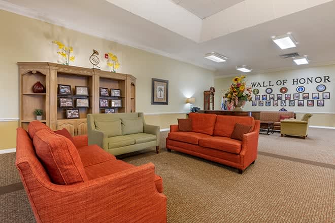 A cozy living room setup with colorful sofas and decorative elements.