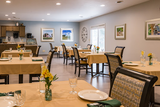 A cozy dining area with neatly arranged tables and decorative elements.