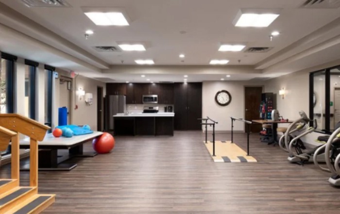 A modern rehabilitation and fitness room with exercise equipment.