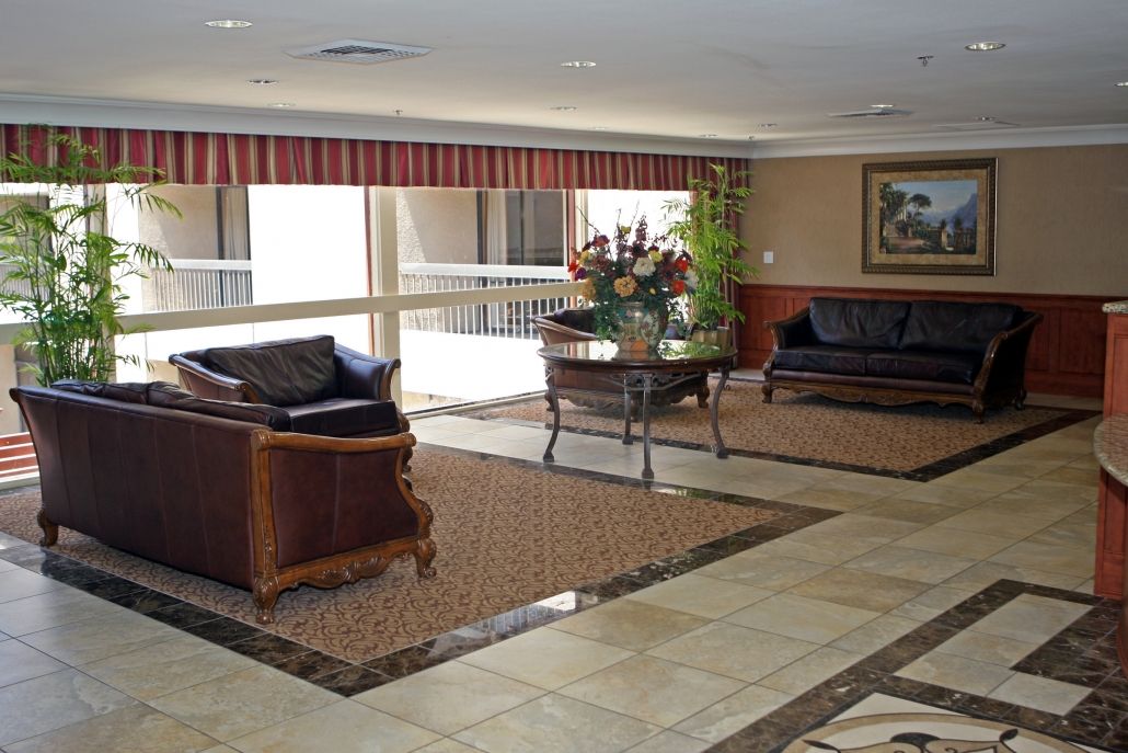 A well-decorated lobby with comfortable seating and a central floral arrangement.