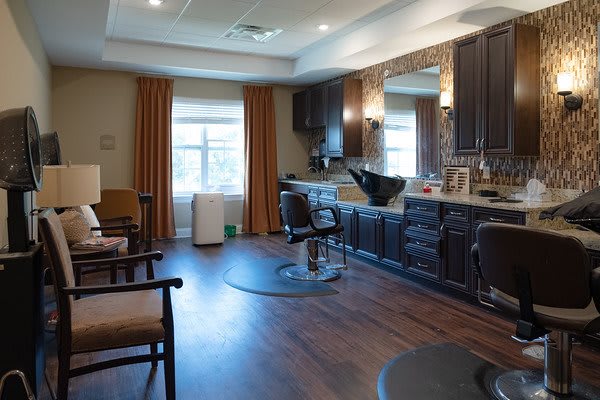 A well-equipped hair salon interior with chairs and mirrors.