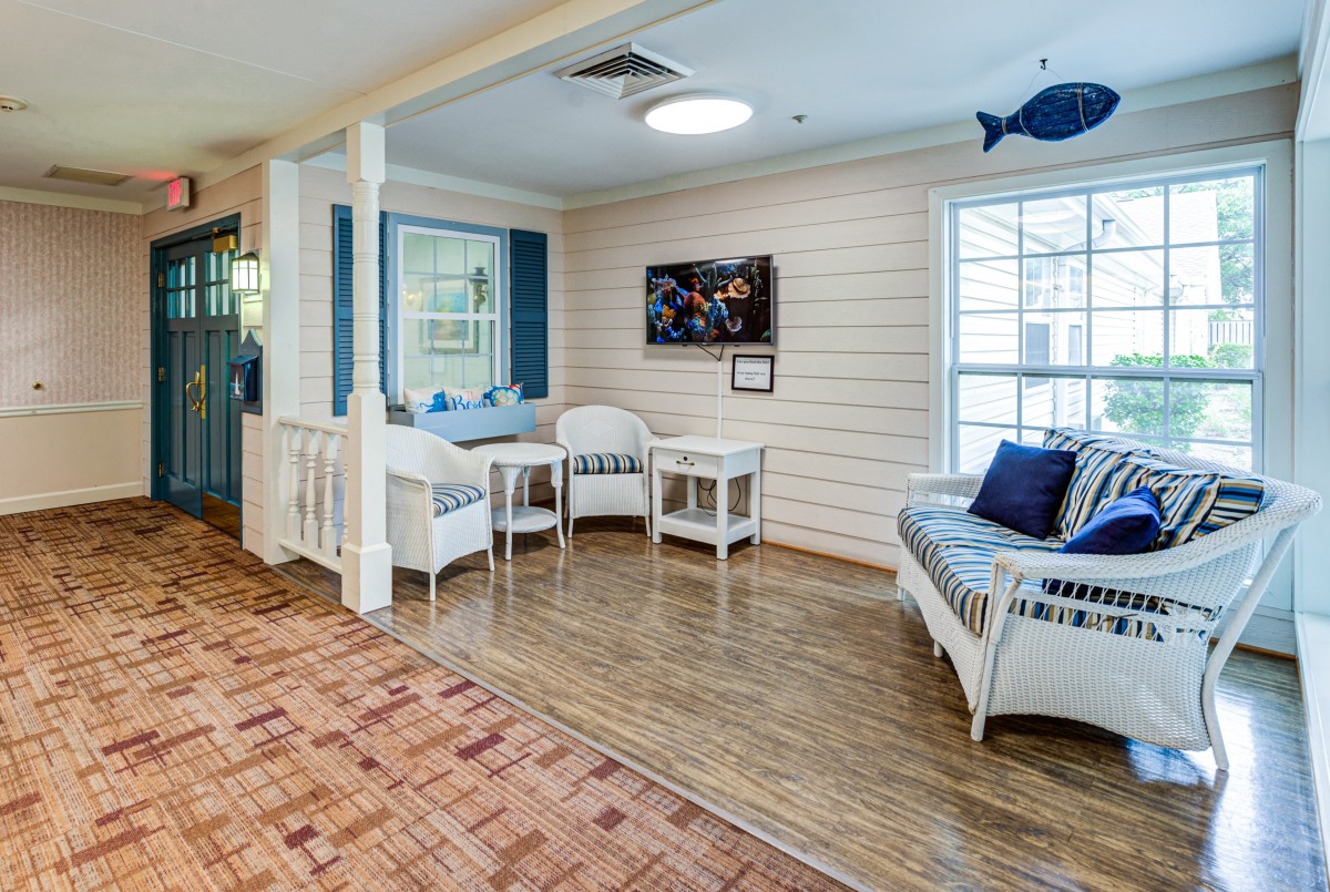 A cozy waiting area with wicker furniture and decorative accents, enhanced by natural light.