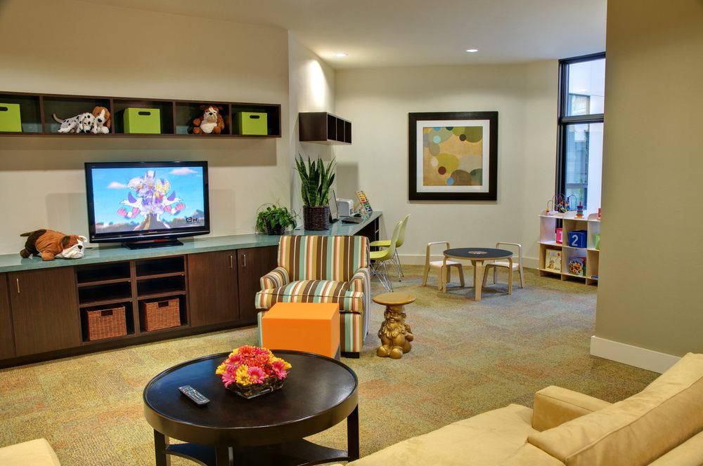A modern living room featuring a television, stylish furniture, and tasteful decor.