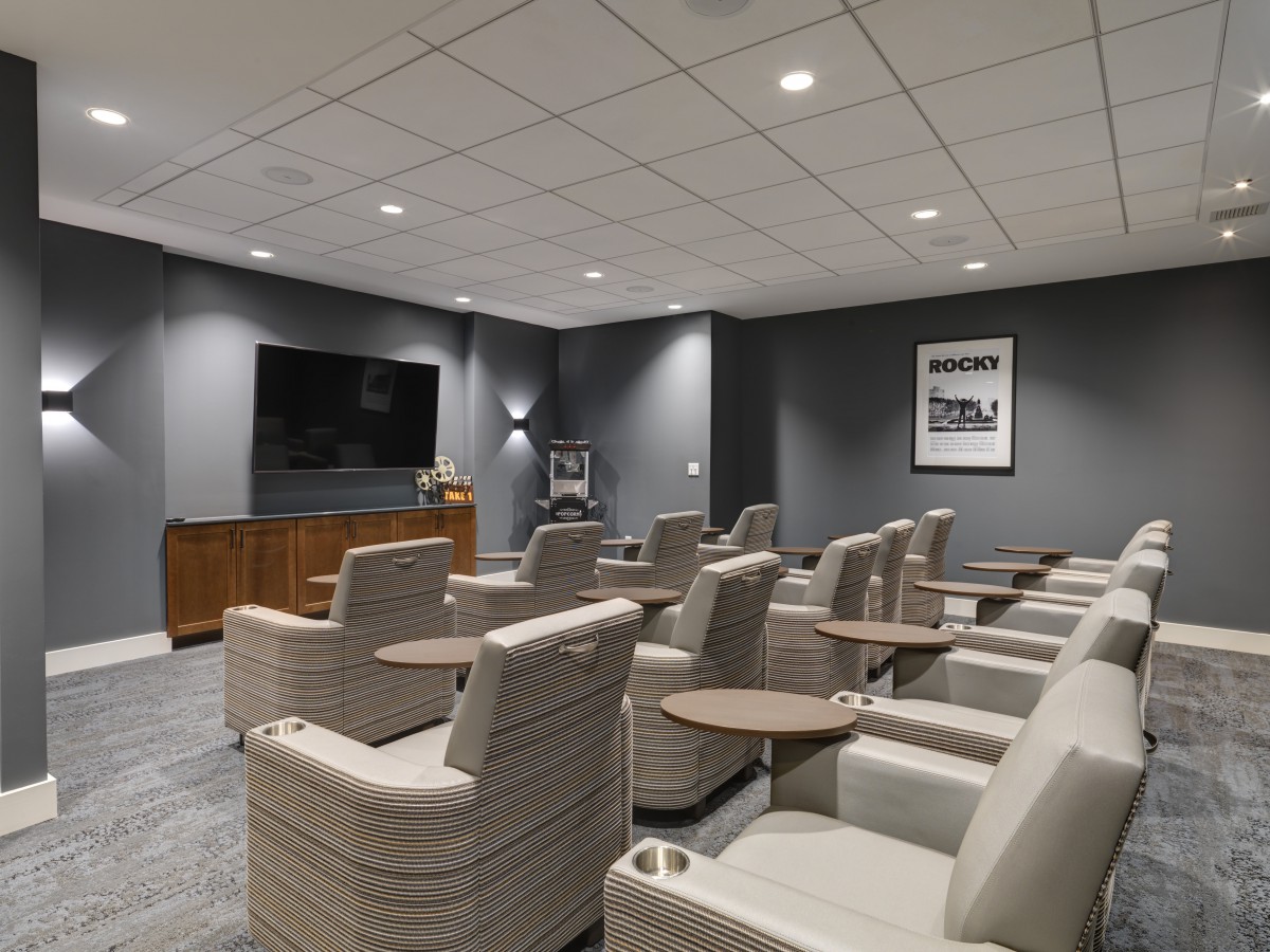 A modern home theater with comfortable seating and a large television.