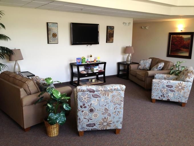 A cozy living room with couches, a television, and decorative elements.