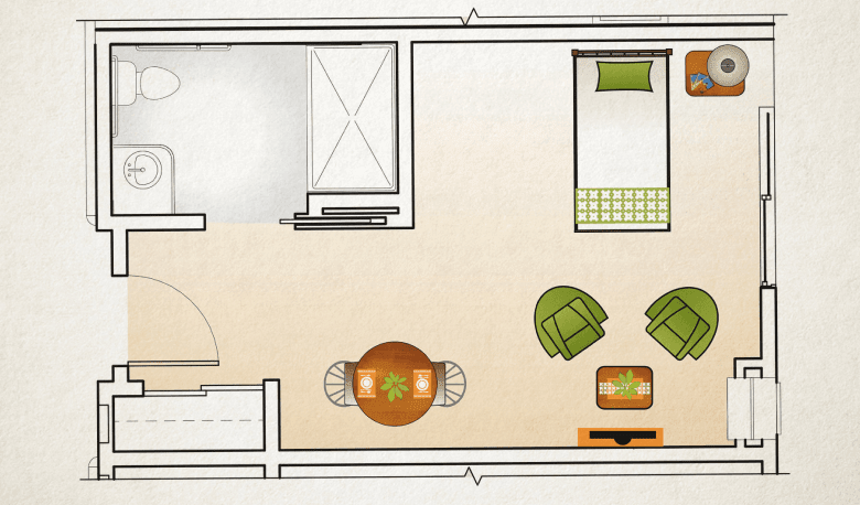 A floor plan showing a single room with a bed, seating area, and dining table.