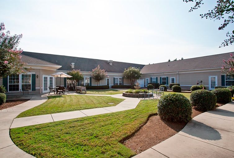 A well-maintained courtyard with pathways, landscaping, and surrounding buildings.
