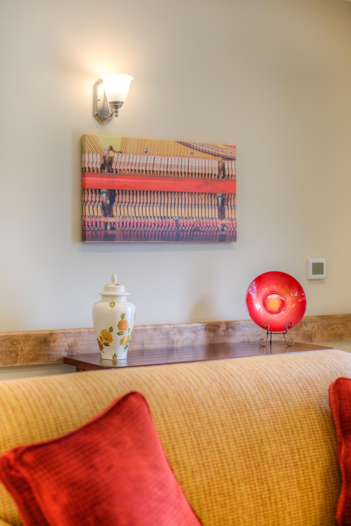 A cozy living room corner with a painting and decorative items.
